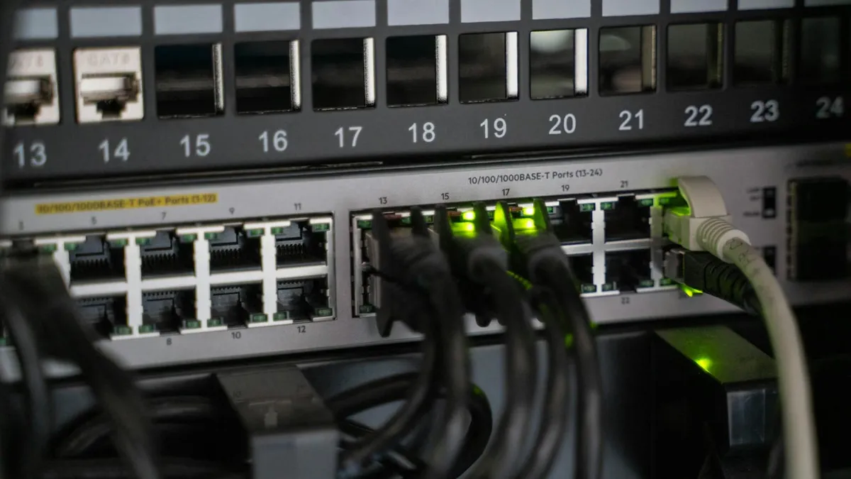 Networking equipment with connected cables, showcasing modern technology infrastructure.