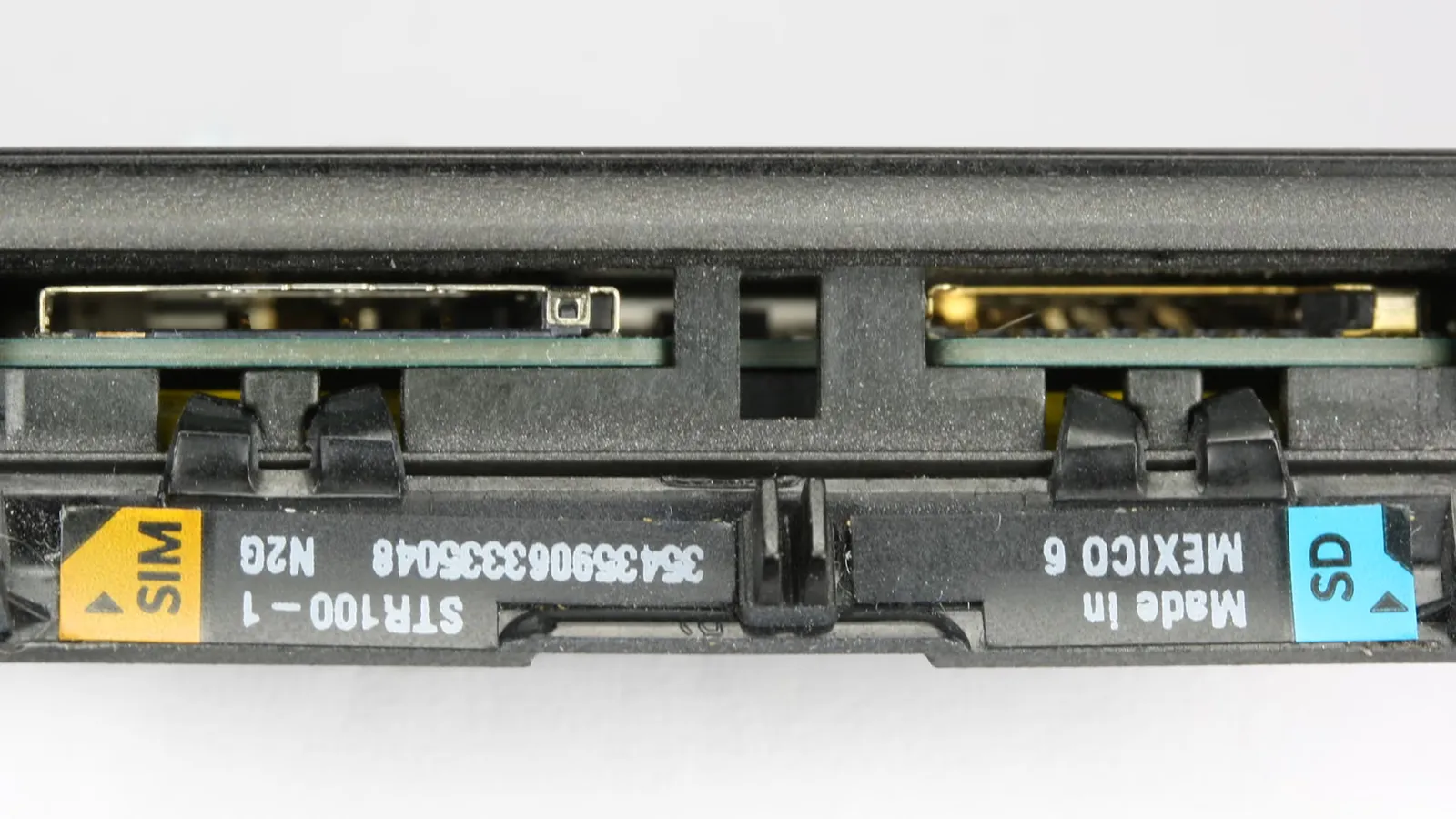 Close-up of a SIM card being inserted into a mobile phone slot
