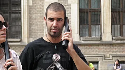 A mobile phone displaying an incoming international call on screen.