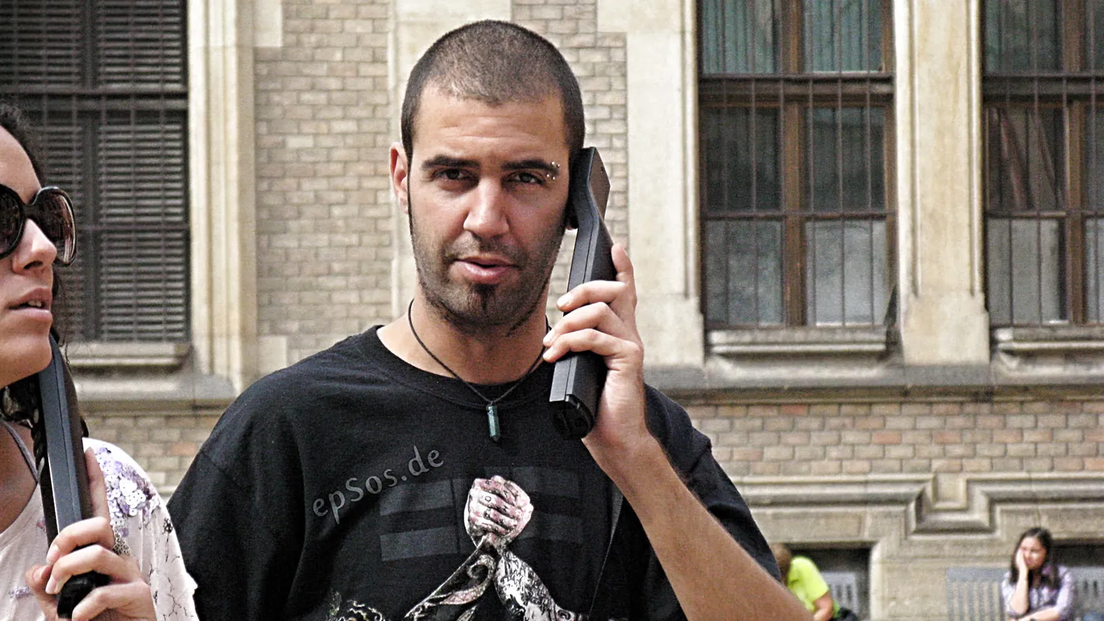 A mobile phone displaying an incoming international call on screen.
