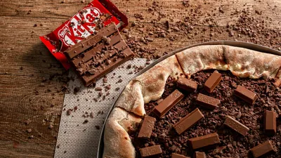 Indulge in a unique fusion of pizza and KitKat chocolate bars, perfect for dessert lovers.