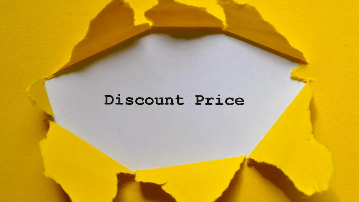 Eye-catching image of torn yellow paper revealing the words 'Discount Price.'