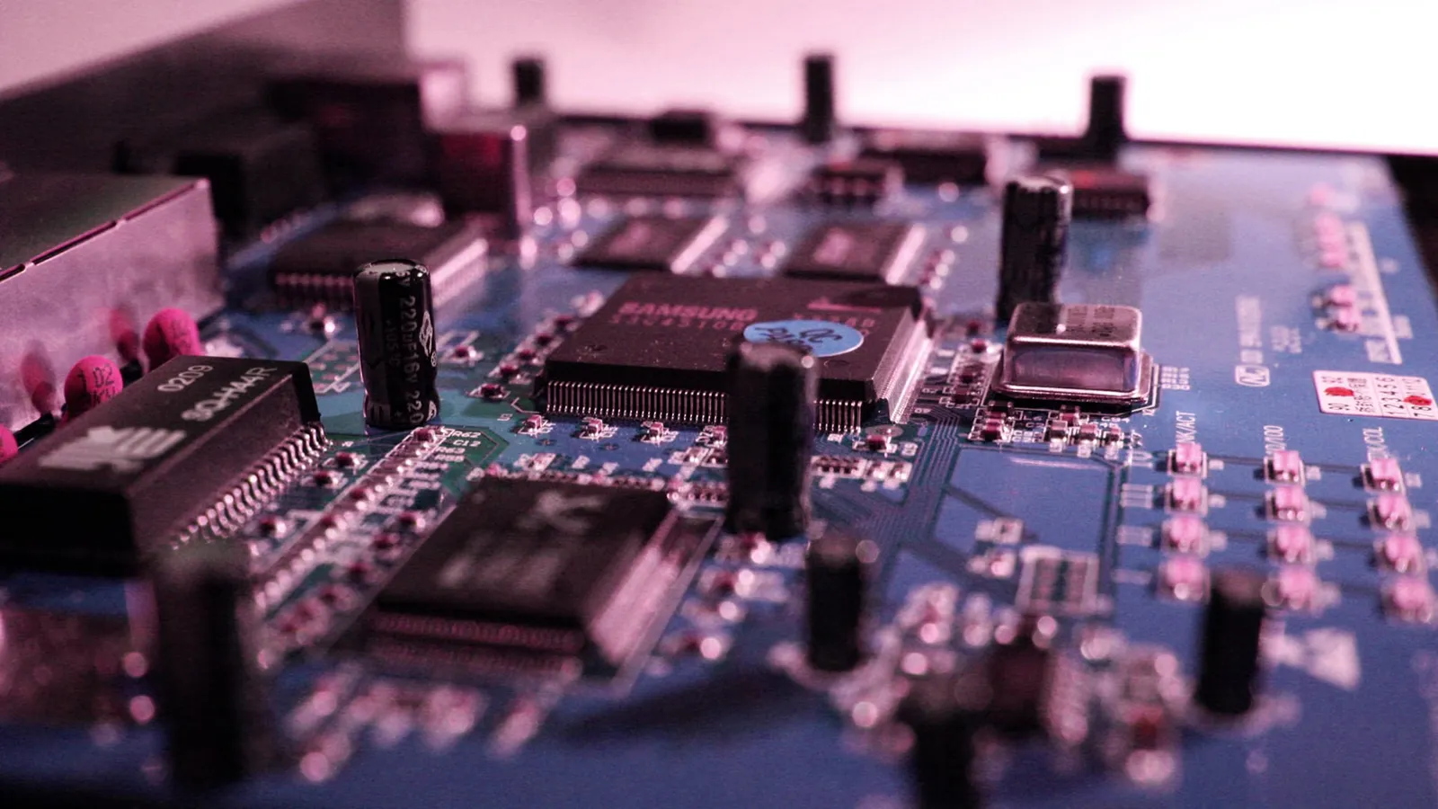 Close-up of a broadband router with illuminated status lights and ethernet ports