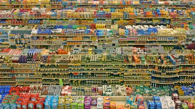 A shopping basket with groceries and receipt at a UK supermarket checkout, representing consumer purchases and promotional claims.
