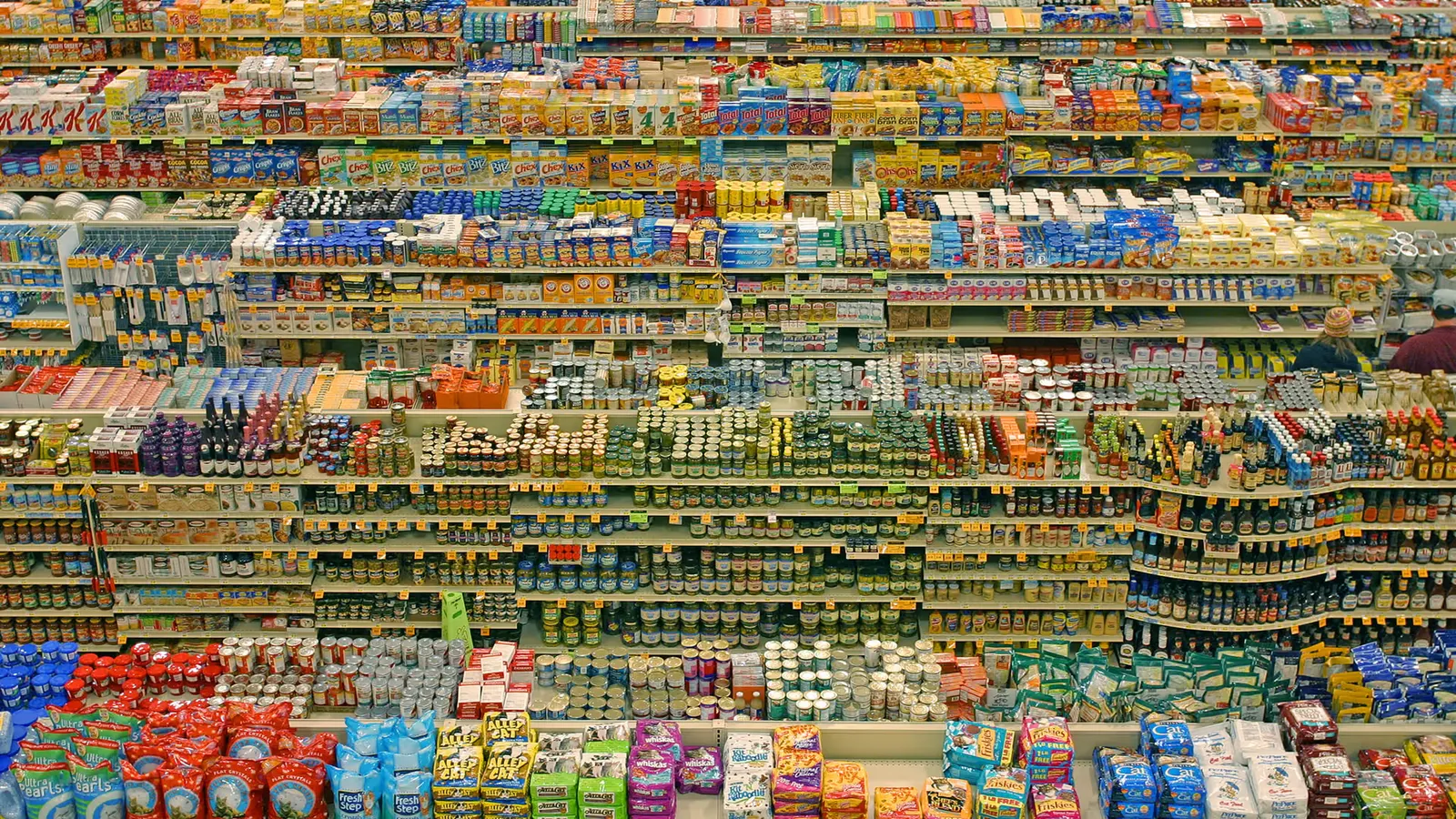 A shopping basket with groceries and receipt at a UK supermarket checkout, representing consumer purchases and promotional claims.