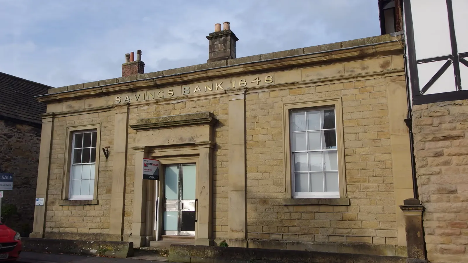 Exterior of a traditional UK savings bank building representing National Savings and Investments.