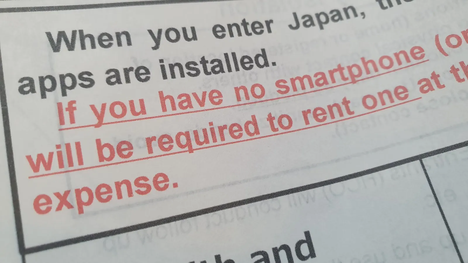 Closeup of a smartphone screen displaying a warning message, representing mobile phone scams and fraudulent activity.