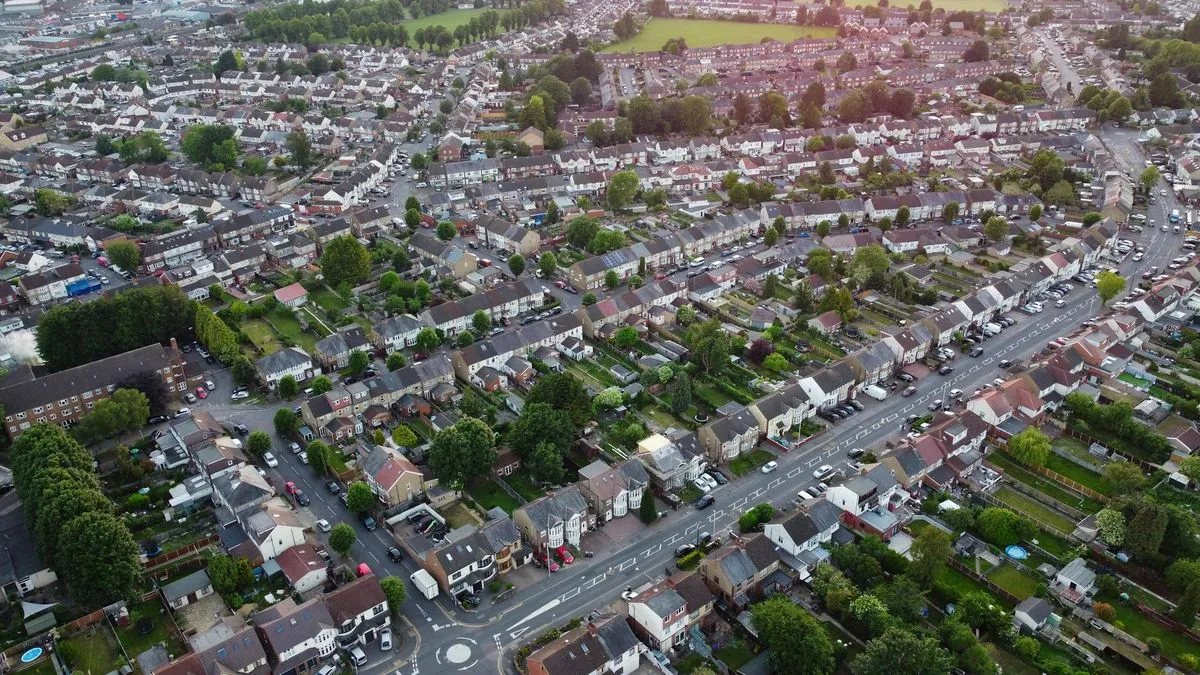 An aerial view of a residential area with many houses and streets, illustrating an area code.