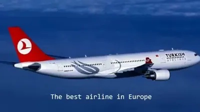 A white Turkish Airlines plane with a red tail flies against a clear blue sky.