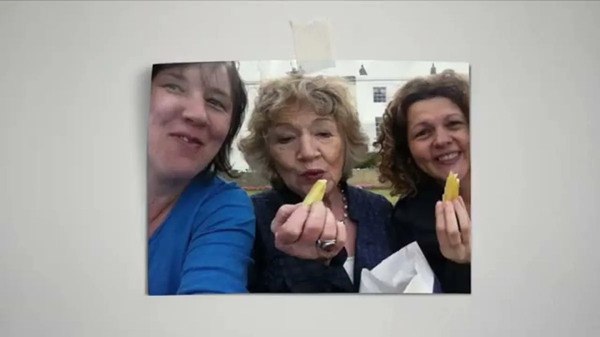 Three women, including the main subject, smile and hold chips in a selfie-style photo.