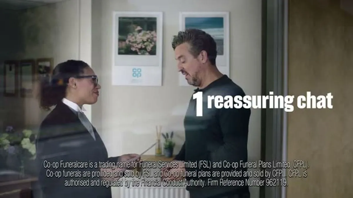 A man and a woman in a suit stand facing each other, talking, with text '1 reassuring chat' overlaid.