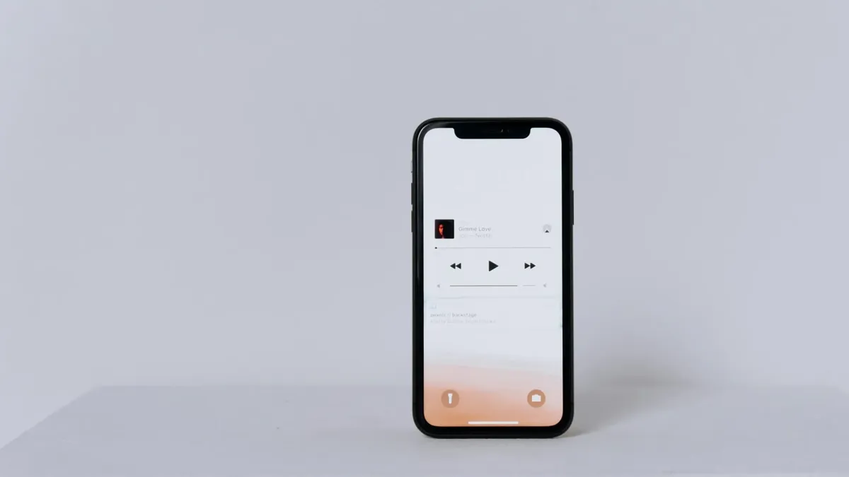 A minimalist smartphone displaying a music app set against a white background.