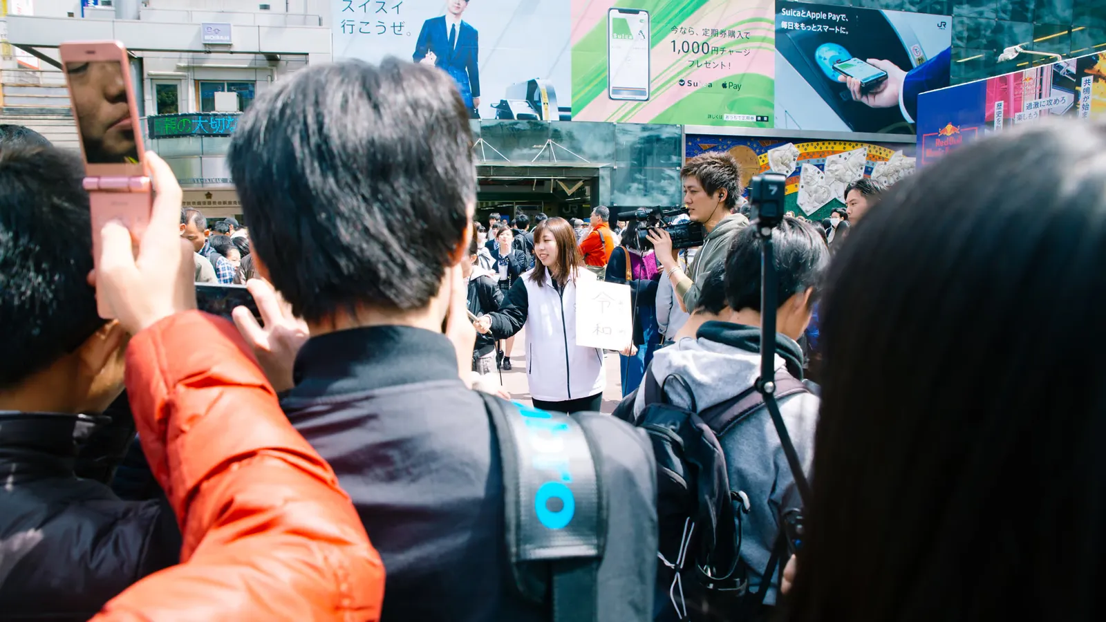 A person listening to music through headphones near a smartphone, representing advertising and audio content.