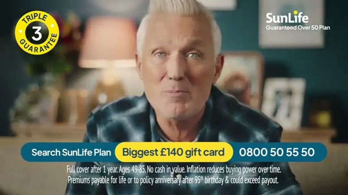 A close-up of Martin Kemp, a man with white hair, looking intently at the camera with a slight smirk.