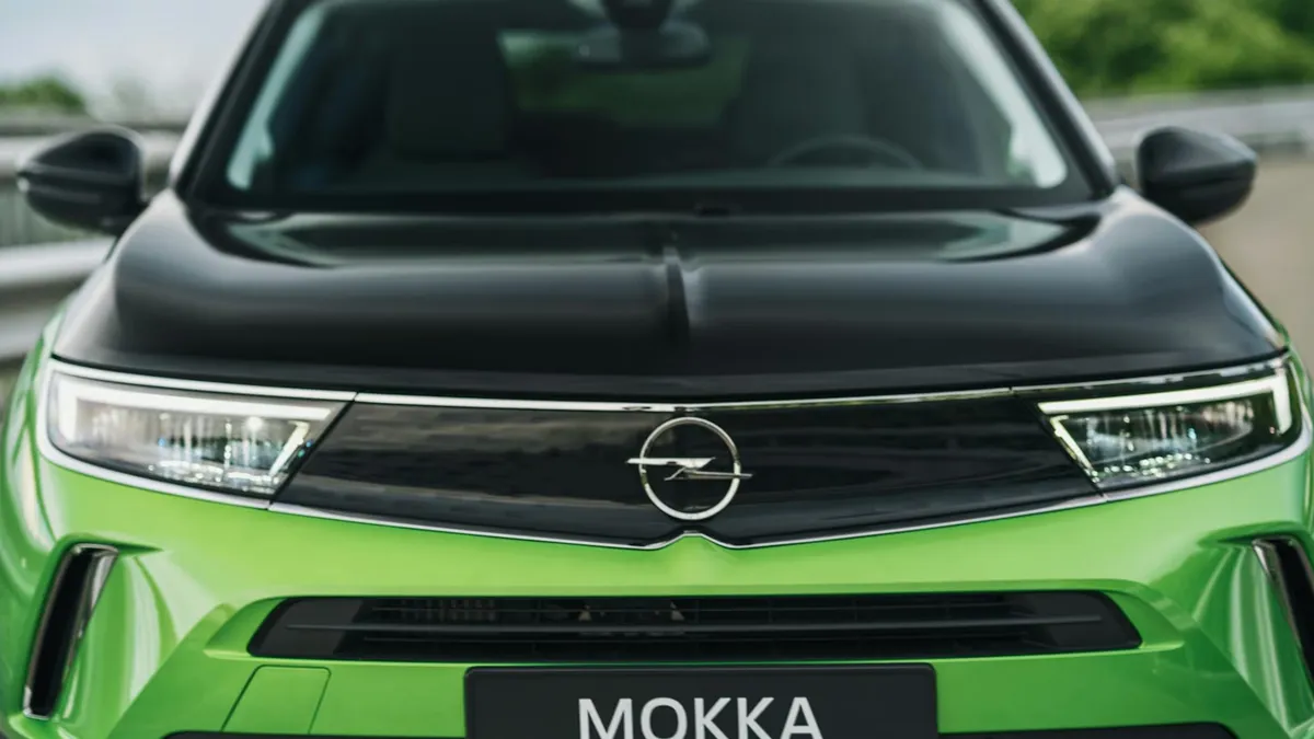 Close-up view of the front of a green Opel Mokka-e electric vehicle.