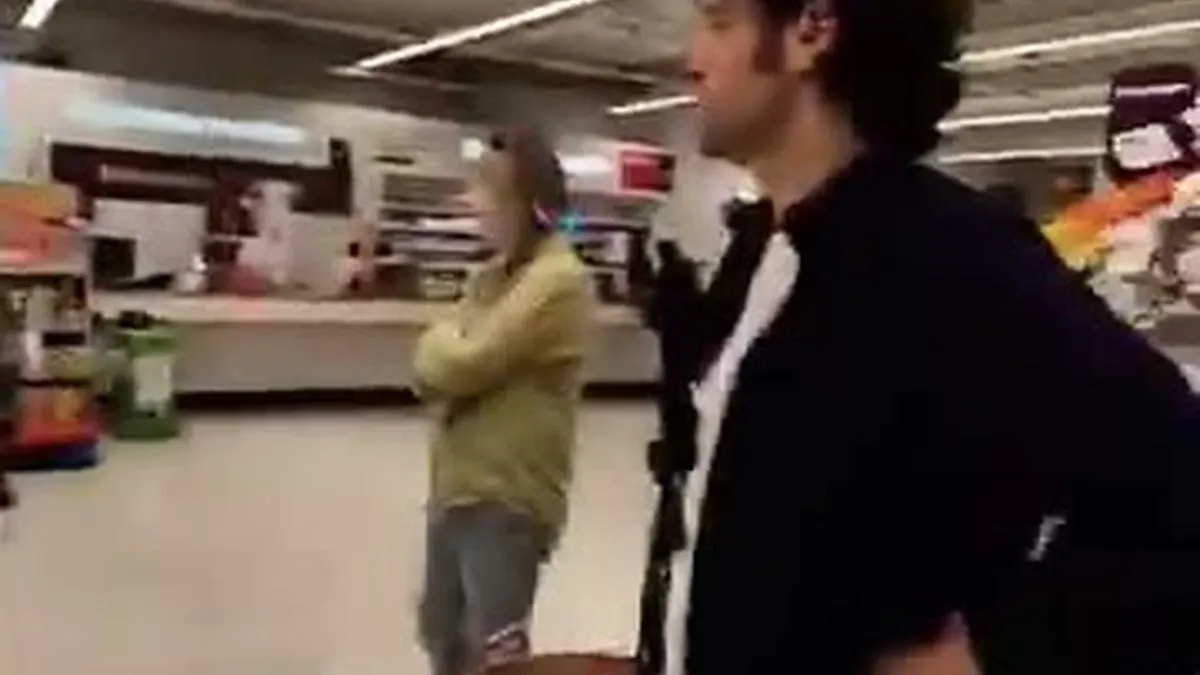Yiannis Vassilakis, a man with dark curly hair, stands in a Sainsbury's UK store, looking up and to the right.