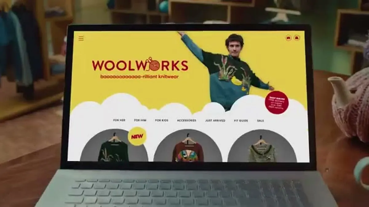 A laptop screen displays the 'Woolworks' website with a man in a sweater posing.